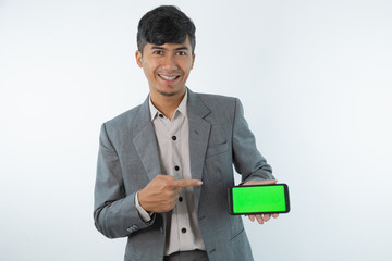 Portrait of Asian Young Business man showing smart cell phone with green screen phone isolated on white background.