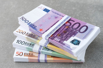Euro currency money. Cash money, euro bills. Stacks of Euro notes on concrete background in five...