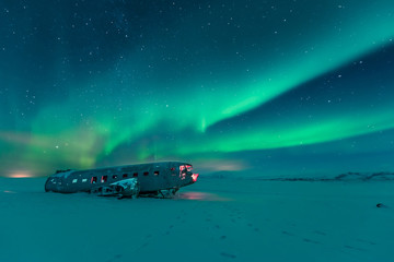 Northern lights over plane wreckage in iceland