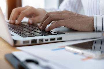 Business women using laptop to checking the company performance chart. Business concept.