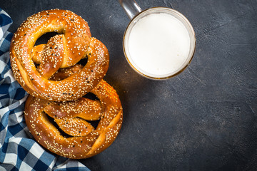 Oktoberfest food beer and bretzel on black.