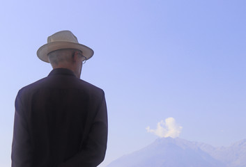rear view of a senior man looking at a mountain