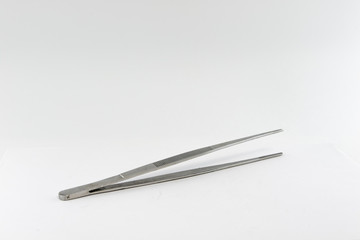 Old stainless steel tweezers. Isolate on a white background.