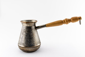 Copper cezve with wooden handle on a white background