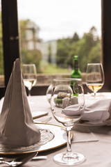 Glass of wine on the table by the window. Interior of a classic restaurant in an old castle. Traveling in Europe. Served tables and antiquity.