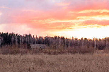 Lonely old barn in a sunset in countryside in November in Latvia