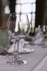 A glass on the table for wine. Interior of a classic restaurant in an old castle. Traveling in Europe. Served tables and antiquity.