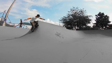 Skater having fun in skatepark concrete bowl, bowl skating