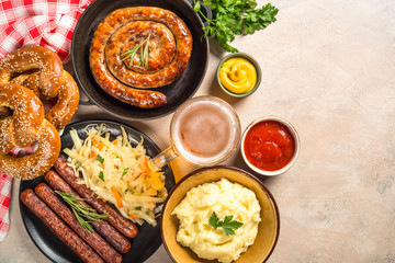 Oktoberfest food - sausage, beer and bretzel.