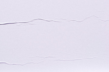 Creases on a white sheet of paper close-up.