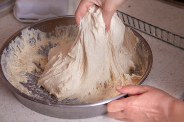 woman hand kneading yeast dough