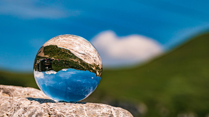 Crystal ball alpine landscape shot at the Höfatsblick near the famous Nebelhorn summit near...