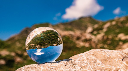 Crystal ball alpine landscape shot at the Höfatsblick near the famous Nebelhorn summit near...