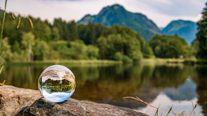 Crystal ball alpine landscape shot with a lake at Oberstdorf, Bavaria, Germany