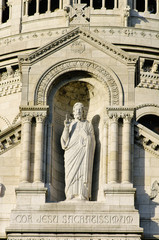 The sculpture of Jesus Christ on the exterior of the Basilique du Sacre Coeur de Monmartre in Paris, France