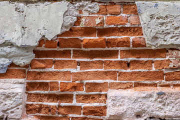 Broken brick wall background. Destroyed plaster.