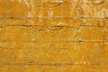 Old yellow concrete wall background.