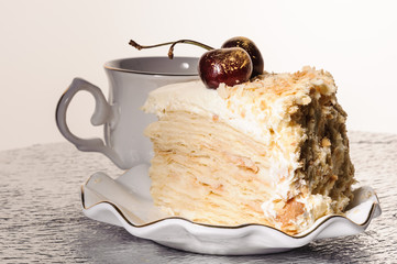 golden napoleon decorated cake with cherry, homemade pastry shop, handmade, a cup of tea, piece,...
