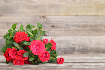 Red roses on wooden background