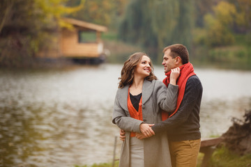 couple on autumn walk outdoors. Two lovers in autumn park. Love and tender touch