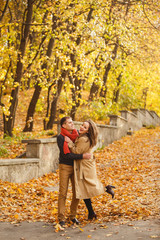 couple on autumn walk outdoors. Two lovers in autumn park. Love and tender touch. Gentle hugs