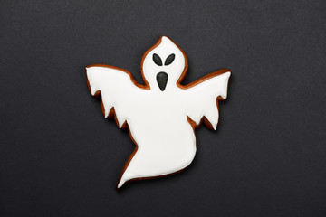 The hand-made eatable gingerbread Halloween ghost on black background