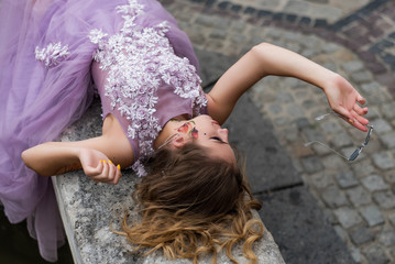 Portrait of young gil wearing dress and sneakers and socks. tattoes over her arms and face. Close up. City walk.