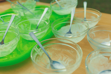 Empty dirty plates with spoons on a bright green tray.