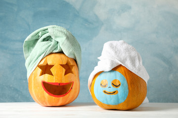 Funny pumpkins with towels on white background, space for text