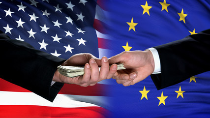 USA and EU officials exchanging money, flag background, international trade