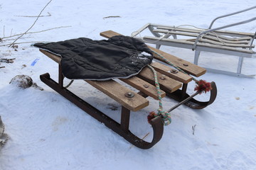 Vintage Ukrainian sled from iron and wood on the snow. Winter rest. Having fun outdoors.