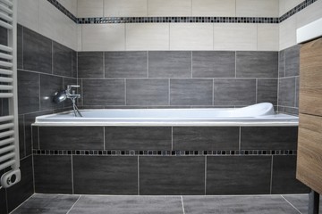Modern built in bathtub with decorative tiles