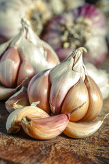 Organic garlic,Closeup garlic on wooden texture on for cooking on dark background, concept healthy lifestyle.Fresh peeled garlics and bulbs.