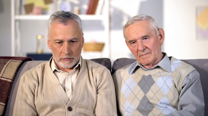 Two desperate old men looking thoughtful, problem depression, old age crisis