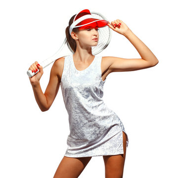 girl tennis player in a white dress in a sun visor with a tennis racket. White background. Studio photography.
