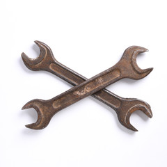 Old rusty stainless steel crescent wrench isolated on white top view