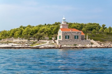 The Sucuraj Lighthouse. It is located on the easternmost point of the island of Hvar in Croatia. View of lighthouse from yacht. Holiday in Croatia. Ship transportation.