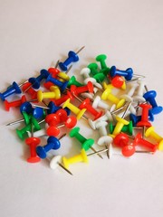 colorful push pins on white background