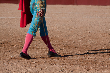 Fototapeta na wymiar Spainish bullfighter walking slowly toward the bull to give the next pass with the muleta in the Bullring, Spain