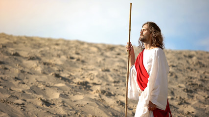 Jesus with closed eyes enjoying sun, mental talk with Father Lord, blessing