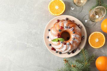 Cake with powder sugar and berries on grey table. Happy new year concept