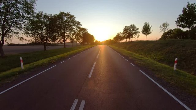 On a rural road to sunset, pov