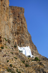 Photo of picturesque Monastery of Panagia Hozoviotissa built on a steep cliff with view to Aegean...