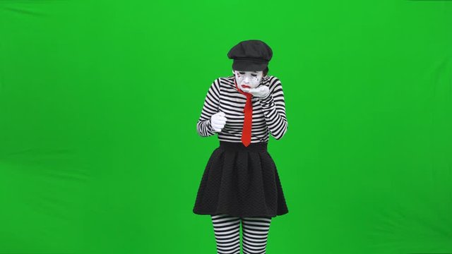 Mime girl crying, collecting tears in a palm. Chroma key.