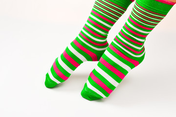 Woman in green socks isolated on white background. Top view.
