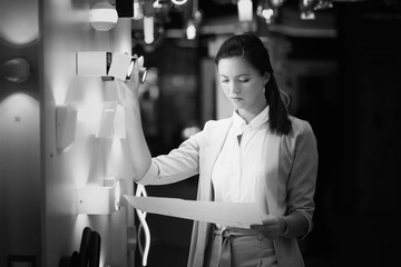 Female interior designer chooses lighting for her new project