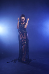 Obraz premium Young sexy woman dancer posing in the smoke