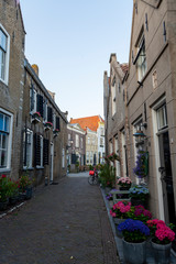 Fototapeta na wymiar Street view in small Dutch town Goedereede on sunset, Zeeland, Netherlands