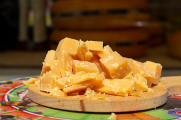 Tasting of old Dutch organic cheese in blocks outside cheese shop