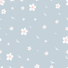 Seamless pattern different size of cherry blossom background, Cute cartoon Hand drawn on pastel tone,Vector cute tiny spring flowers with bird flying on blue background